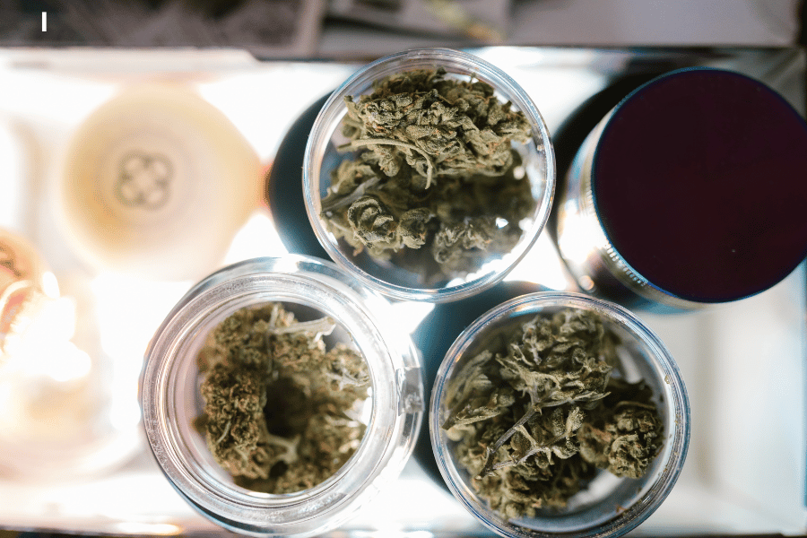 Glass jars filled with high-quality THCA flower stored in a cool, dark space to preserve potency and terpenes
