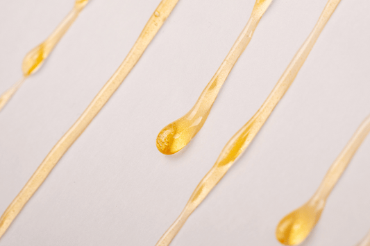 Close-up of golden cannabis extract, representing fresh frozen vs. dried THCA flower comparison