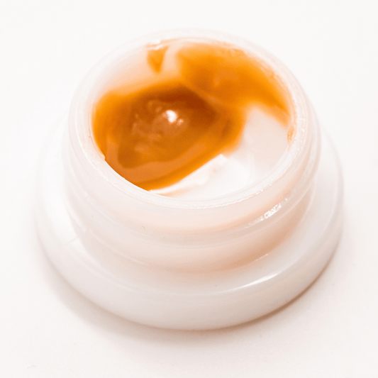 Premium Hindu Kush THCA solventless live rosin dabs with a golden texture and rich aroma.