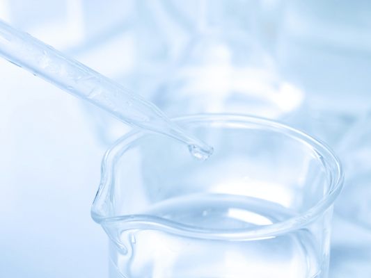 Close-up of a laboratory dropper with liquid, symbolizing scientific research and innovation, relevant to exploring Bisabolol's therapeutic properties in wellness and cannabis.