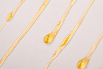 Close-up of golden cannabis extract, representing fresh frozen vs. dried THCA flower comparison