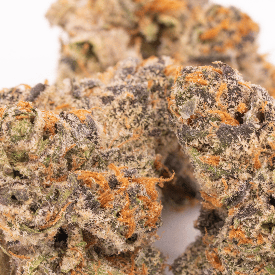 Dense group of Lemon Head THCa buds with high 30.7% THCa, showcasing sativa-dominant effects and sour lemon aroma.